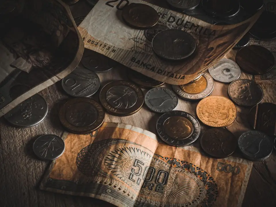 Old coins and banknotes on a table