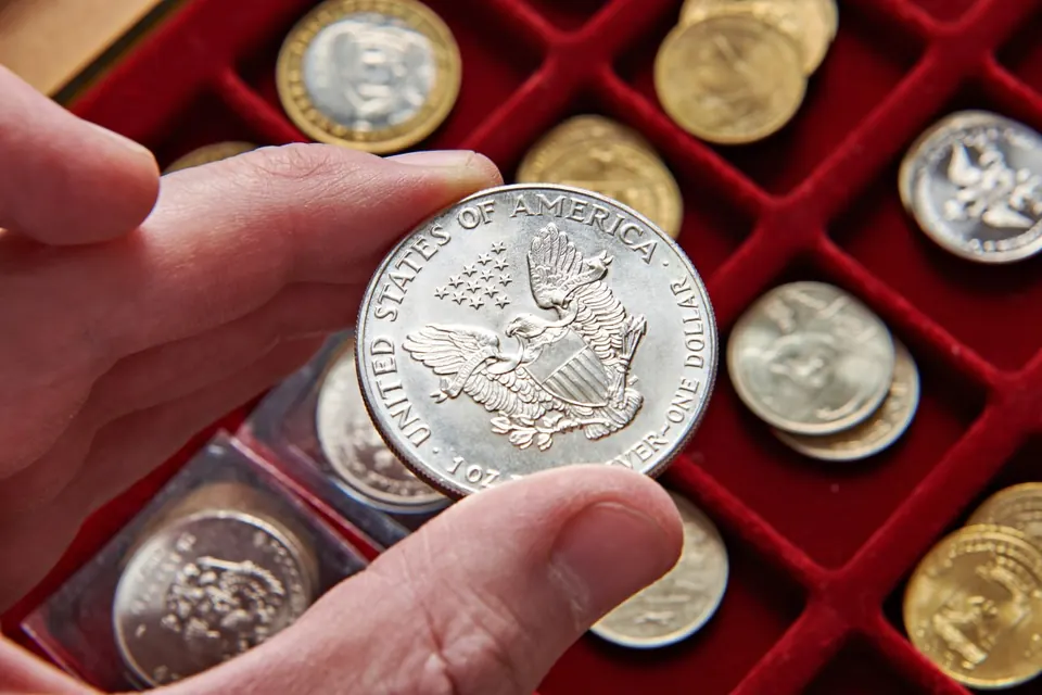 Silver bullion coins on grey