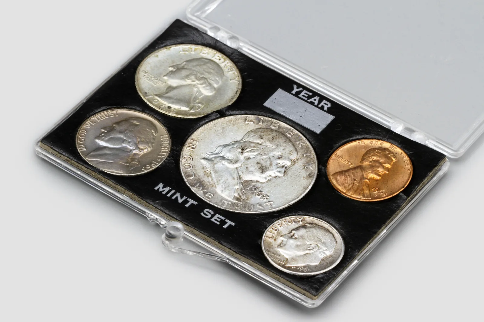 US mint set in a plastic holder with a quarter, nickel, half dollar, cent and dime